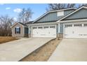 New construction home featuring blue siding, a gray stone accent and a two-car garage with a concrete driveway at 140 Mission Terrace Dr, Whiteland, IN 46184