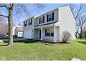 Two-story home with vinyl siding, black shutters, a two-car garage, and a well-maintained lawn at 18924 Planer Dr, Noblesville, IN 46062