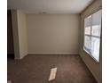 Bright living room featuring neutral walls, carpet flooring, and a window with natural light at 18924 Planer Dr, Noblesville, IN 46062