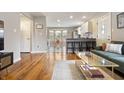 Open concept living room with hardwood floors, natural light, and seamless flow to the kitchen at 23 Greenacre Dr, Brownsburg, IN 46112