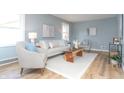 Stylish living room showcasing light-colored furniture, a wooden coffee table, and bright walls at 3723 N Olney St, Indianapolis, IN 46218