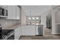 Modern kitchen featuring stainless steel appliances, white cabinets, and open layout at 4160 Douro Trl, Westfield, IN 46062