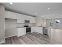 Well-lit kitchen with stainless steel appliances, white cabinets, and spacious layout at 4160 Douro Trl, Westfield, IN 46062