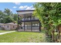 Charming two-story home featuring a spacious double-decker porch with stylish black railings and a well-maintained lawn at 4242 Winthrop Ave, Indianapolis, IN 46205