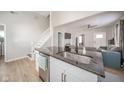 Kitchen island with granite countertop, stainless steel sink, and an open layout with an adjacent staircase at 436 E Staat St, Fortville, IN 46040