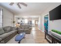 An open living room featuring hardwood floors, gray couches, and seamlessly connects to the kitchen at 436 E Staat St, Fortville, IN 46040
