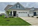 Charming home featuring a two-car garage, and a well-manicured front lawn at 50 Hovden Dr, Cicero, IN 46034