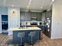 Modern kitchen with stainless steel appliances, an island with counter seating, and gray cabinetry at 50 Hovden Dr, Cicero, IN 46034