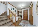 Welcoming foyer with hardwood floors, staircase, and views into the living area at 504 Stony Creek Cir, Noblesville, IN 46060