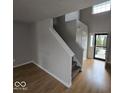 Welcoming entryway with staircase, natural light, and wood and carpet flooring at 6114 Arrowhead Dr, Anderson, IN 46013