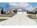 Charming single-story home with a large driveway and a two-car garage in a well-kept neighborhood at 6117 Arctic Cir, Indianapolis, IN 46237