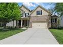 Charming two-story home featuring a brick and siding exterior, attached garage, and well-maintained front lawn at 6126 Golden Eagle Dr, Zionsville, IN 46077