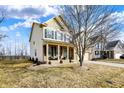 Attractive two-story home with a covered porch and manicured lawn at 6126 Golden Eagle Dr, Zionsville, IN 46077
