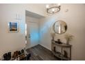 Inviting entryway features stylish decor, modern lighting, a round mirror, and durable wood-look flooring at 615 Conner Creek Dr, Fishers, IN 46038