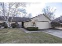 Charming single-story home with stone and siding, features an attached garage and a well-maintained front yard at 615 Conner Creek Dr, Fishers, IN 46038