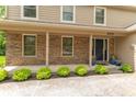 Welcoming front entrance featuring a brick facade, well-maintained landscaping, and a stylish front door at 6530 Grant Wood Ct, Indianapolis, IN 46256