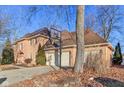Brick home featuring a three-car garage, basketball hoop, and well-maintained landscaping at 6878 Black Oak East Ct, Avon, IN 46123