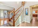Grand staircase with wooden railing and carpeted steps leading to the upper level at 6878 Black Oak East Ct, Avon, IN 46123