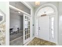 Bright foyer with a decorative front door, leading to a spacious office with glass French doors at 6897 Abercon Trl, Noblesville, IN 46062