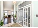 Inviting foyer offering views to the living room with a fireplace and an office with glass doors at 6897 Abercon Trl, Noblesville, IN 46062