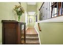 Inviting foyer with hardwood floors, staircase, and elegant decor creating a warm and welcoming atmosphere at 700 Greenford N Trl, Carmel, IN 46032