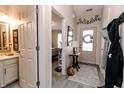 Welcoming foyer with stylish decor, showcasing a glimpse of the bedroom and an adjacent half-bathroom at 7221 Broyles Ln, Indianapolis, IN 46217