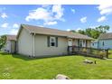 A single-story home with light siding and a front ramp for easy access at 817 Hamilton St, Lebanon, IN 46052