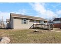 Side view of cozy house featuring a ramp for easy access, set against a bright, cloud-filled sky at 817 Hamilton St, Lebanon, IN 46052