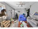 Cozy living room showing hardwood floors, ceiling fan, and eclectic furnishings, creating a cozy atmosphere at 817 Hamilton St, Lebanon, IN 46052