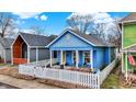 Charming blue home with cozy porch sitting area and picket fence at 912 Harlan St, Indianapolis, IN 46203