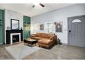 Comfortable living room features a brown leather sectional, fireplace, modern decor, and stylish flooring at 912 Harlan St, Indianapolis, IN 46203