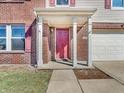 Charming front porch with white columns leads to a red door of the brick and vinyl sided home at 10830 Clear Spring Dr, Camby, IN 46113