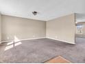Spacious living room with neutral walls, carpeting, and natural light creates a warm and inviting atmosphere at 10830 Clear Spring Dr, Camby, IN 46113
