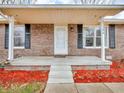 Inviting covered front porch with brick accents, offering a welcoming entrance to the home at 12386 S Hillview Dr, Columbus, IN 47201