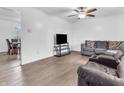 Bright living room featuring hardwood floors, a ceiling fan, and comfortable seating area at 12386 S Hillview Dr, Columbus, IN 47201