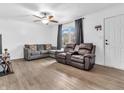 Spacious living area with natural light, ceiling fan, hardwood floors, and cozy seating arrangement at 12386 S Hillview Dr, Columbus, IN 47201