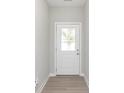 Bright entryway featuring a white door with glass window and wood-style flooring at 1257 Newton St, Avon, IN 46123