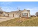 Exterior view of the home, showcasing the attached garage and neutral siding at 1280 Vicksburg S Dr, Greenwood, IN 46143
