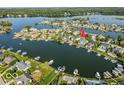 Aerial view of waterfront homes showcasing a pool and boat docks at 13499 Marjac Way, Fishers, IN 46055