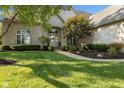 Welcoming front entrance of brick home with manicured landscaping and stone walkway at 13499 Marjac Way, Fishers, IN 46055