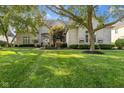 Stately white brick home with meticulously maintained lawn and mature trees at 13499 Marjac Way, Fishers, IN 46055