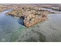 Wide aerial view of lakefront property and frozen lake at 18 Point Ln, Arcadia, IN 46030