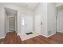 Inviting entryway with hardwood floors and neutral paint, leading to other rooms at 2056 Suda Dr, Carmel, IN 46280