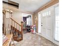 Welcoming foyer with tile flooring, staircase, and charming details creating a warm and inviting atmosphere at 2141 E County Road 200 N, Danville, IN 46122