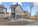 Modern two-story home featuring a two-car garage and gray trim at 2406 Carrollton Ave, Indianapolis, IN 46205