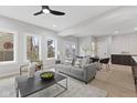 A bright living room featuring a gray sofa, modern furniture, and lots of natural light at 2406 Carrollton Ave, Indianapolis, IN 46205