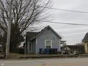 Exterior view of a two-story home with weathered siding and an overgrown front yard at 250 S Marion St, Morgantown, IN 46160