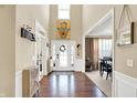 Bright and airy home foyer with high ceilings, hardwood floors, and views into the dining room at 2504 Boylston Ct, Zionsville, IN 46077