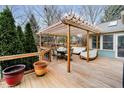 Inviting outdoor deck with pergola, perfect for dining and relaxation with comfortable seating at 5109 Kingswood Dr, Carmel, IN 46033