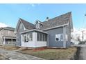 Charming two-story home with gray siding and a welcoming enclosed front porch at 516 W Washington St, Lebanon, IN 46052